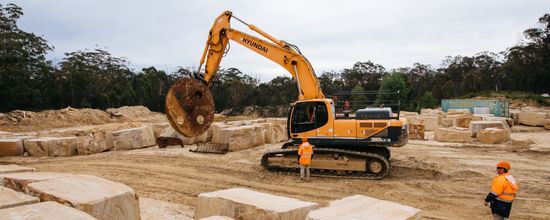 Workers operating earthmoving equipment at Wilton Sandstone Quarry